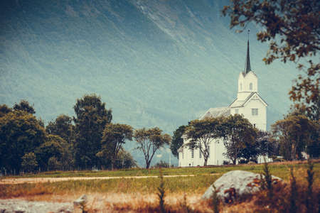 Mountain landscape and the white wooden Oppstryn Church in Stryn Municipality in Sogn og Fjordane county, Norway.の写真素材