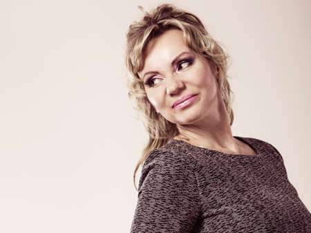 People, portrait concept. Attractive mature woman. Amazing female has beautiful make up and long blonde hair.の写真素材