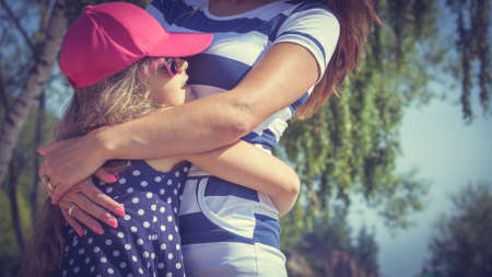 Love and good feelings in family. Childhood and parenthood concept. Lovely cute girl and woman in summer holidays. Adorable mommy and her child daughter together.の写真素材