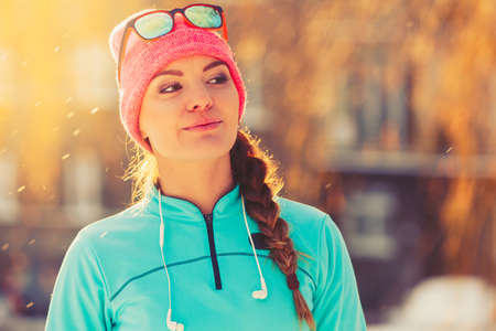 Fit girl in winter aura. Presenting beauty in snow. Health nature fitness fashion concept.の写真素材