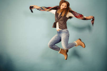 Movement fun and fashion concept. Attractive woman is jumping up. Beautiful girl with long hair...