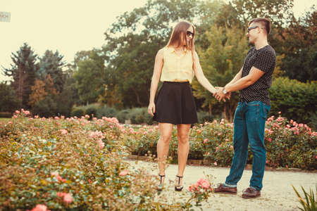 Love romance relationship dating concept. Cheerful girl holding hands in park. Young girl and boy...