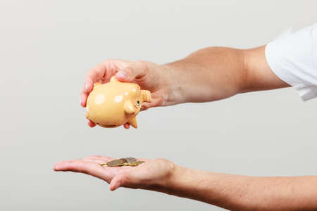 Spending money concept. Male hands with coins of polish zloty pln. Savings.の写真素材