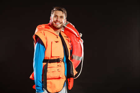 Lifeguard man in life vest jacket with ring buoy lifebuoy supervising.