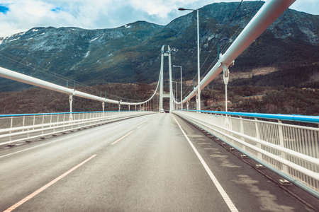 Suspension bridge in Norway. View from car. Norwegian infrastructure.の写真素材
