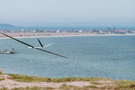 RC remotely controlled soaring plane model sailplane on blue sky in brisk windの写真素材
