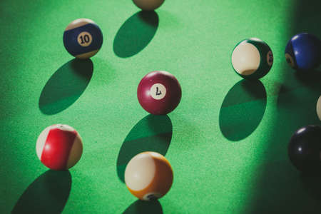 Billiard cue balls on green table. Pool game