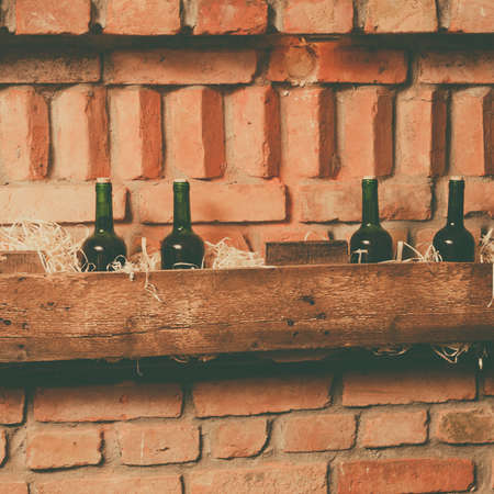 wine bottles on the wooden shelf in cellarの写真素材