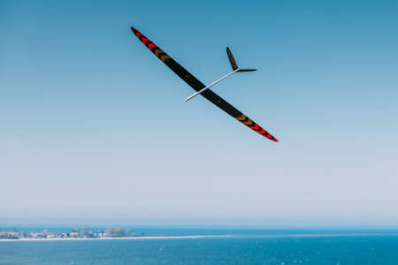 RC remotely controlled soaring plane model sailplane on blue sky in brisk windの写真素材