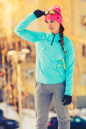 Female health and beauty in winter. How to stay fit and pretty. Fashion fitness nature concept.