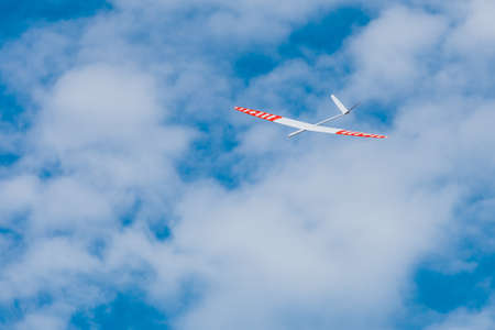 RC remotely controlled soaring plane model sailplane on blue sky in brisk windの写真素材