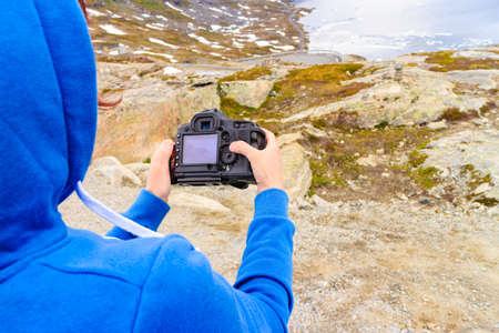 Tourism holidays and travel. Woman tourist taking photo with camera, enjoying Djupvatnet lake view in Stranda More og Romsdal, Norway Scandinavia.の写真素材