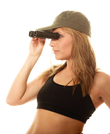 Beautiful sexy woman in military clothes with binoculars, fit army girl isolated on whiteの写真素材