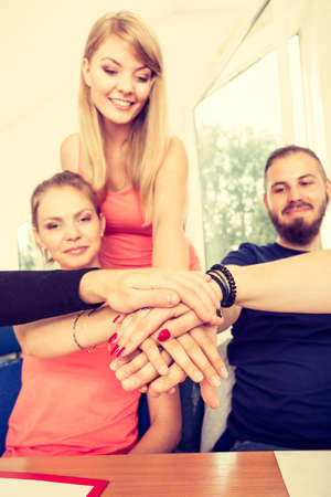 Education, friendship, success and teenage concept. Team of friends college students showing unity...