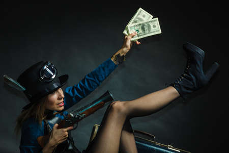 Fashionable subculture weapon concept. Steampunk girl with cash. Young gorgeous lady in victorian...