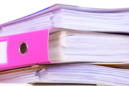 Paperwork. Stack of file folders, ring binders on office table dask.の写真素材