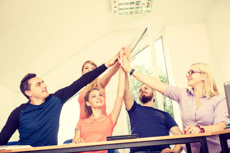 Education, friendship, success and teenage concept. Team of friends college students showing unity...