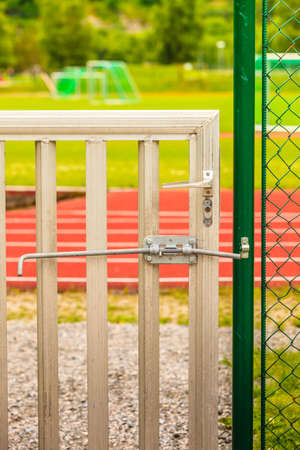 Padlock locked on stadium gate close upの写真素材