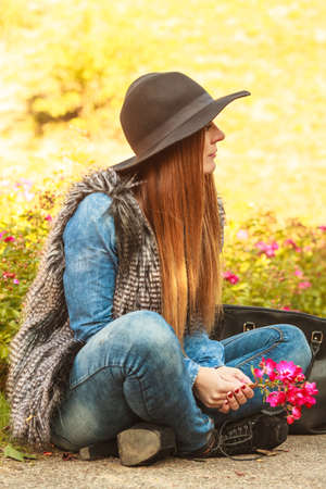 Freedom and leisure. Gorgeous adorable woman holding pink flowers. Romantic portrait of beautiful...