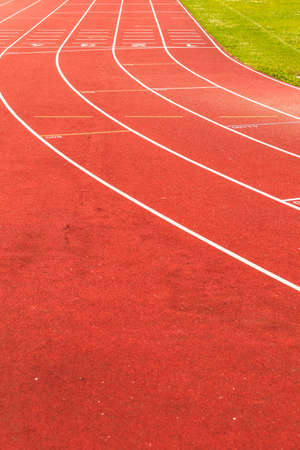 Empty red running track in stadium closeupの写真素材