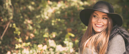 Gorgeous stylish young woman wearing fashionable clothes. Portrait of girl in black hat outside.の写真素材