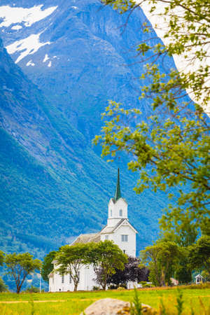 Mountain landscape and the white wooden Oppstryn Church in Stryn Municipality in Sogn og Fjordane county, Norway.の写真素材