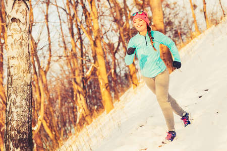 Woman doing winter jog in morning, how to keep exercising in cold weather, fitness health nature...
