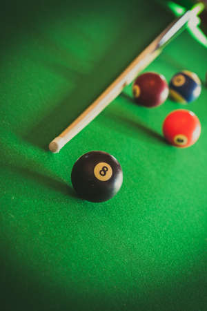 Billiard balls and cue stick on green table. Pool gameの写真素材