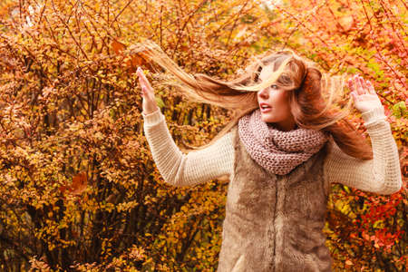 People moving outdoors concept. Shot of movement in the park. Beautiful and stylish lady wearing fashionable clothes. Woman has long hair.の写真素材