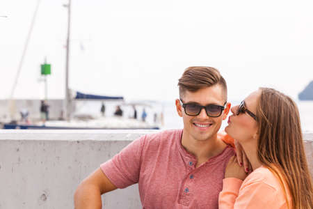 Love romance relationship feelings dating concept. Couple chilling at seafront. Young girl with her boyfriend enjoying time together.の写真素材
