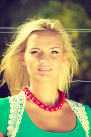 Summer time, shining sun concept. Sunny portrait of nice woman. Attractive lady has amazing necklace.の写真素材