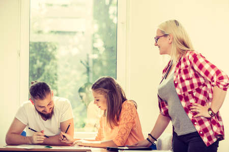 Education concept. Highschool students having fun during a break in classroom interiorの写真素材