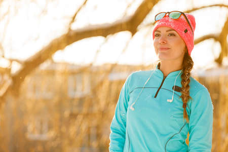 Natural beauty in the winter. Young girl in the park. Health nature fitness fashion concept.の写真素材