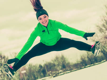 Sports activity in winter time, healthy lifestyle concept. Fit woman athlete girl training outdoor...