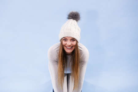 Attractive woman in winter cap and gray sports thermolinen underwear for skiing training studio shot...