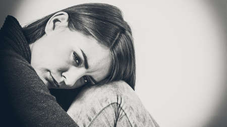 Face emotional expression of sadness. Unhappy worried thinking woman, depressed girl deep in thought. Female contemplating life.の写真素材