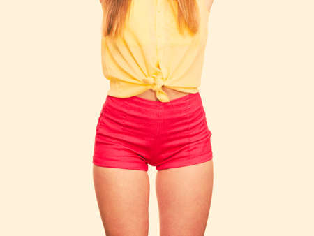 Closeup of sexy alluring woman hips. Slim girl wearing red summer shorts. Hotness fashion concept.の写真素材