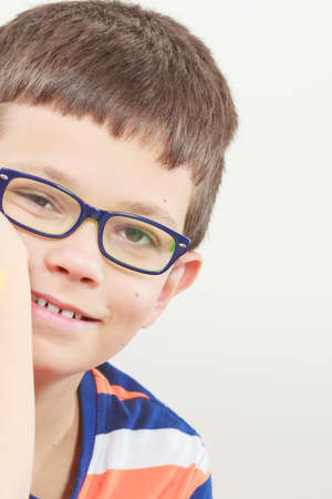 Portrait of happy positive cute little boy kid in glasses.の写真素材