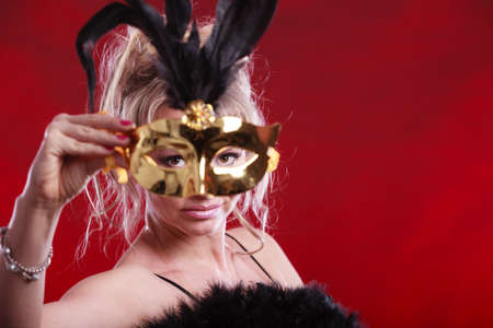 Party fashion people concept. Attractive woman wearing carnival mask. Beautiful mature lady wearing...