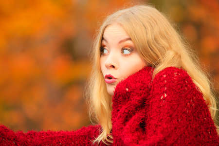 Portrait of blonde woman outdoor. Funny cute girl having fun surprised face emotionの写真素材