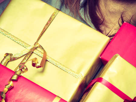 Holiday, xmas winter time season and special occasion. Closeup of male hands holding a lot of presents gifts boxesの写真素材