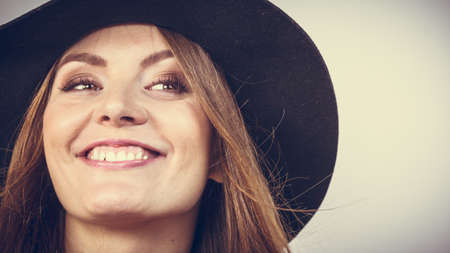 Female autumnal fashion. Smiling woman wearing black hatの写真素材