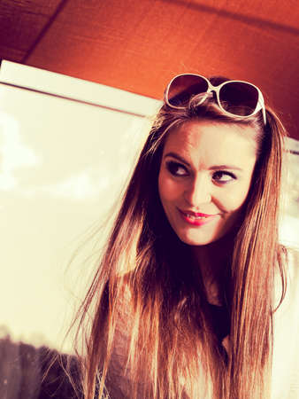 Fashion and posing during sunny day concept. Beautiful girl in summer. Young pretty woman spending spare time.の写真素材