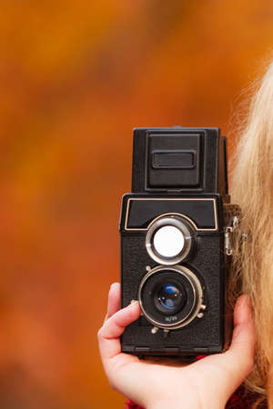Female hand girl passionate photographer holding old vintage camera outdoor
