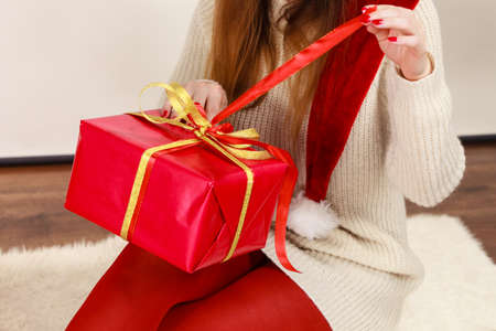 Occasions gifts people concept. Christmas xmas winter season. Woman opening or wrapping red box gift