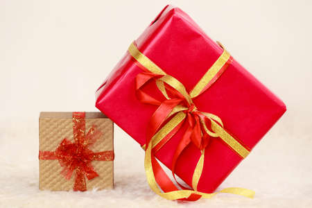 Two gift boxes red and golden. Christmas time concept.