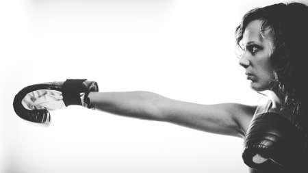 Sportsmanship fairplay and strong body. Young woman fighting boxing with opponent. Sport and fitness healthy lifestyle exercising. Black & whiteの写真素材