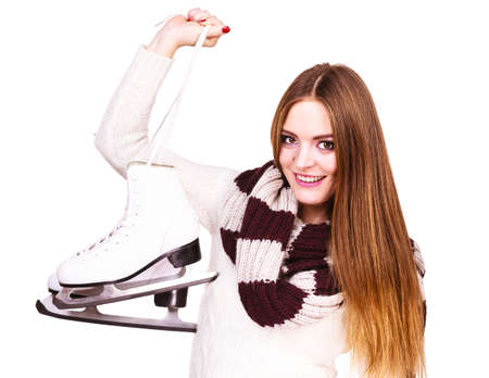 Woman with ice skates getting ready for ice skating, winter sport activity. Smiling cheerful girl...