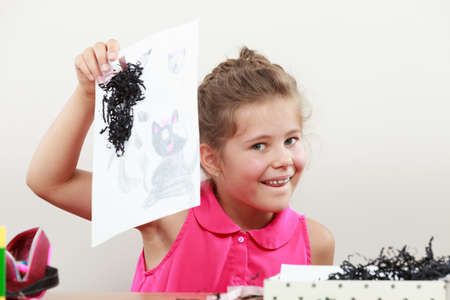 Little girl draw in the classroom. Being creative in elementary ageの写真素材