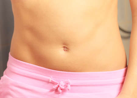 Skincare and bodycare concept. Part body slim fit female belly, perfect abdomen muscles. Woman in...